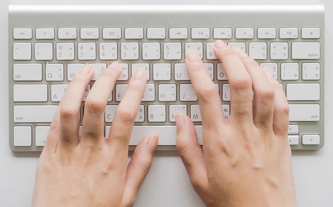 Hands tying on a keyboard